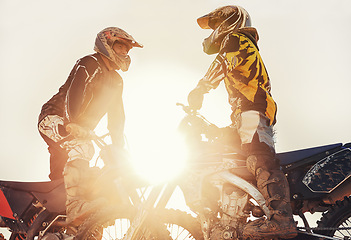 Image showing Sport, racer or people on motorcycle outdoor on dirt road with relax after driving, challenge or competition. Motocross, lens flare or dirtbike driver or friends on offroad course or path for sunset