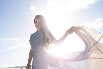 Image showing Portrait, sunshine and woman with desert, fashion and weekend break with travel and getaway trip. Face, person or girl with holiday or summer with wind and vacation with lens flare or dress trail
