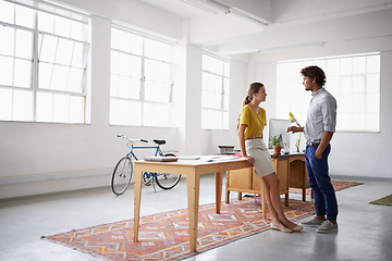 Image showing Businessman, partner and together in office for discussion, close and meeting for copywriting project. Man, woman and talk for idea, plan and gallery for research and articles at desk at work