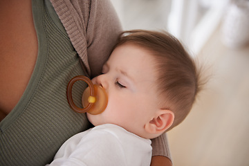 Image showing Baby, sleeping and pacifier with relax on mother for healthy development, growth and tired in bedroom. Child, rest and dummy in mouth with nap, dreaming and wellness in nursery for comfort and trust