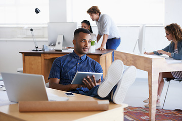 Image showing Male, tablet and laptop in office with desk for thinking, research or business. African person and architect with technology, internet or web online for design, innovation and planning in Dublin.
