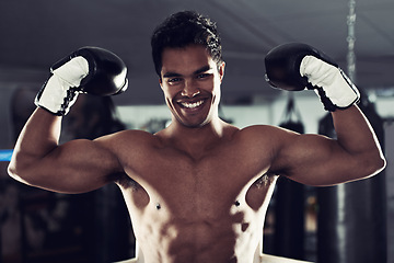 Image showing Boxer, portrait and gym with flex, boxing ring and smile for workout or training. Man, exercise and fitness for health, wellness and achievement or winning with celebration for professional fight