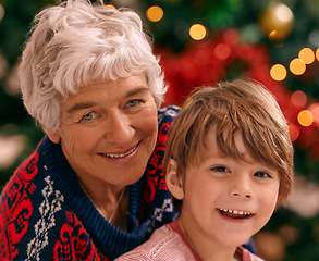 Image showing Christmas, portrait and celebration in living room, grandma and grandchild smile with happiness. House, elderly woman and kid together for holiday as family in lounge, tree and love in home