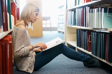 Image showing Woman, library and reading book on floor for studying education or university scholarship, learning or college. Female person, campus and academic exam in Canada for research, lesson or literature