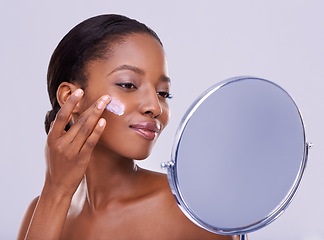 Image showing Mirror, cream and black woman for beauty and dermatology, cosmetic product and shine on white background. Skincare, lotion or sunscreen for moisturizer, antiaging with skin and facial in studio