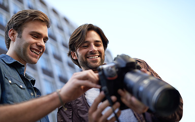 Image showing Men, friends and photographer with digital camera in urban, streets and town with media for portfolio in London. Collaboration, creativity and photography in city to build profile for project.