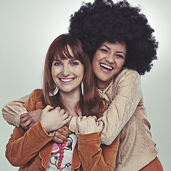 Image showing Vintage, portrait and friends with retro style, smile and laugh with hug in studio with grey background. Girls, happiness and unique with fashion in outfits, clothes and women with confidence