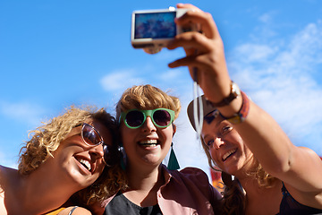 Image showing Friends, group and selfie outdoor for festival, photography and digital camera for portrait. Music, people and blue sky in summer, together and happy with culture of music in carnival and smile