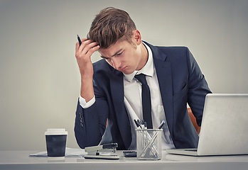 Image showing Man, accountant and laptop with stress for finance, fail or recession in studio with thinking for solution. Person, audit or budget with anxiety for low revenue, profit and frustrated with results