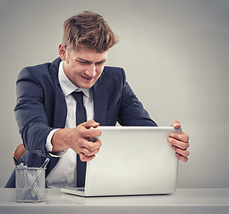 Image showing Man, accountant and frustrated with laptop for finance, fail and recession in studio with anger for loss. Person, audit and budget with anxiety for low revenue, profit and depression with results