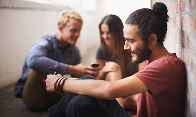 Image showing Technology, typing and students in a hallway, university and connection with social media and lunch break. Group, outdoor and friends in a lobby and smartphone and mobile user with meme and contact