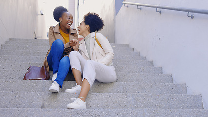 Image showing Happy, laugh and women friends on stairs in a city for fun, bonding and hanging out on the weekend. Funny, conversation and people on steps with comedy, gossip or sharing silly, humor or joke outdoor