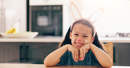 Image showing Girl, child and bunny ears for portrait in home to smile for culture, holiday or festive celebration. Kid, face paint and art for rabbit, Easter and happy for creativity, play or mask in family house