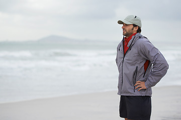 Image showing Fitness, man and thinking break at a beach after training, running or winter morning cardio in nature. Workout, recovery and male runner at the sea for sports rest, breathing or body wellness routine