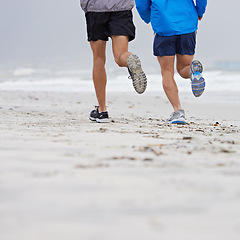 Image showing Beach, legs or friends running for fitness, wellness or training outdoor in nature to workout for body health. Ocean, shoes or people together for exercise, cardio or sport with back on mockup space