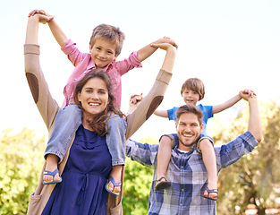 Image showing Portrait, summer and piggyback with family in park together for adventure, bonding or outdoor fun. Mother, father and brother children in nature for freedom, love or travel on holiday and vacation