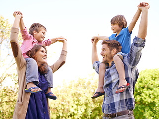 Image showing Smile, nature and kids on parents shoulders in outdoor park or field for playing together. Happy, bonding and young mother and father carrying boy kids for fun in garden in Canada for summer.