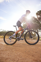 Image showing Cyclist, man and bicycle ride in nature, hill and mountain biking in countryside. Male person, freedom and lens flare for fitness or exercise, hobby and sports for outdoor adventure and off road