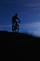 Image showing Cyclist, silhouette and bicycle ride at night, hill and mountain biking in countryside. Person, freedom and sky mockup for fitness or exercise, hobby and sports for outdoor adventure and cycling