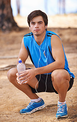 Image showing Portrait, water or runner on break with earphones in outdoor exercise or fitness workout for podcast. Man, ready or male athlete listening to playlist for streaming radio, music or sports training