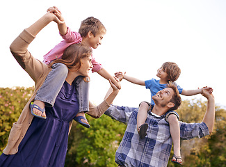 Image showing Excited, nature and children on parents shoulders in outdoor park or field for playing together. Happy, bonding and young mother and father carrying boy kids for fun in garden in Canada for summer.