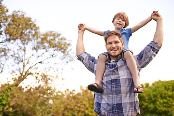 Image showing Smile, nature and child on father shoulders in outdoor park or field for playing together. Happy, bonding and portrait of excited young dad carrying boy kid for fun in garden in Canada for summer.