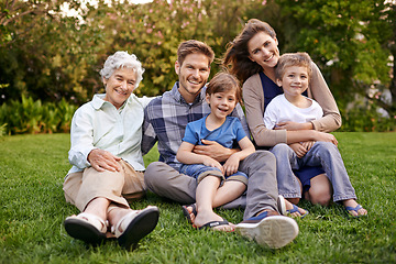 Image showing Nature, portrait and children with parents and grandmother relaxing on grass in outdoor park or garden. Smile, family and boy kids on lawn with mom, dad and grandma for bonding in field together.