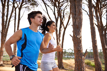 Image showing Fitness, forest or couple in nature running for exercise, training or outdoor workout together. People, fast runners or athletes at a park for sports endurance, wellness or cardio challenge in woods
