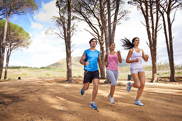 Image showing Fitness, group or friends in nature running for exercise, training or outdoor workout together. People, fast runners or athletes at a park for sports endurance, wellness or cardio challenge in woods