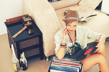 Image showing Woman, hat and record with collection, retro and living room floor for relaxation. Person, couch and vintage for hobby, happiness and stress relief with trendy music and summer recreation with style