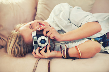 Image showing Woman, camera and couch for retro, photography and fashion in casual outfit for hobby at home. Analog, lens or female photographer in trendy, creative and clothes for relax, shoot and freelance