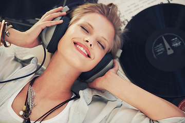 Image showing Happy, music and woman with headphones on floor for streaming subscription, audio and radio. Podcast, smile and above of person listening to playlist, song and track for relaxing in home with vinyl