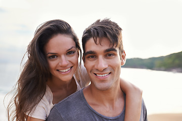 Image showing Couple, beach and piggyback with ocean, smile and nature with travel and date for relationship. Man, woman and indonesia sea for adventure, vacation and tropical holiday with sunshine and portrait