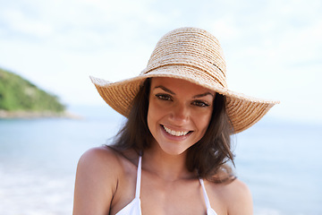 Image showing Beach, smile and portrait of woman for holiday, vacation and adventure for tropical travel. Happy, nature and female person with hat by ocean or sea water on outdoor summer weekend trip by island.