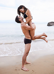 Image showing Playing, embrace and couple on beach with waves, travel adventure and relax on summer island holiday. Ocean vacation, woman and man hug in nature on date together with smile, love and romance in Bali