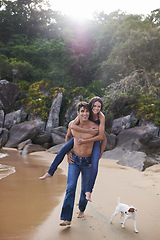 Image showing Beach, piggy back and couple with dog, travel adventure and relax on summer island holiday. Ocean vacation, woman and man happy in nature on romantic date together with smile, love and puppy in Bali