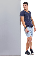 Image showing Male person, studio and advertising with board, casual outfit and smile for sales and marketing. Man, billboard and branding for mockup space, white background and confident advertisement brand