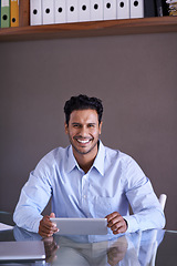 Image showing Businessman, tablet and portrait by desk on social media and connection for online research in office. Entrepreneur, smile face and technology for small business website and scroll in startup company