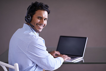 Image showing Man, call center and contact us with CRM and laptop for tech support, web help desk and communication with headset. Customer service consultant, portrait and telecom with mic for telemarketing sales
