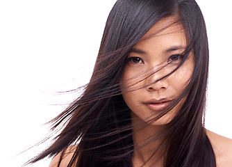 Image showing Woman, portrait and wind for hairstyle in studio, beauty and pride for keratin on mockup space. Asian female person, breeze and shampoo for cosmetic on white background, hair treatment and care