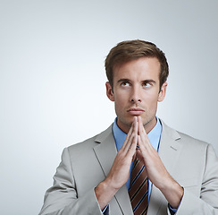 Image showing Businessman, serious and thinking in grey background of studio with professional in suit. Male person, brainstorming and hands together for ideas, corporate and working as employee in company