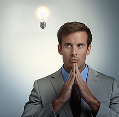 Image showing Thinking, idea or business man with lightbulb for vision in studio isolated on gray background overlay. Inspiration, dream or serious professional problem solving for solution, innovation or decision