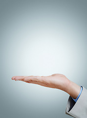 Image showing Open, palm and business person with presentation, mockup and space on isolated on a grey studio background. Closeup, advertising and hand of professional with promotion or show platform for marketing