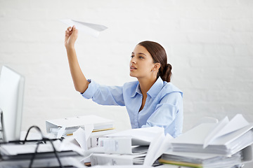 Image showing Corporate, businesswoman and paper plane at desk, sitting and thinking while working. Employee and paperwork with files in professional workspace, procrastination and avoid with distraction game