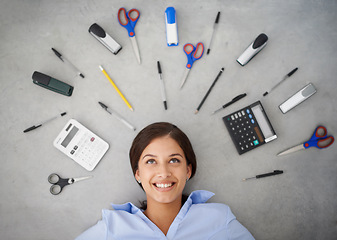 Image showing Happy woman, thinking and stationery with tools for accounting, finance or creative above. Top view of female person, accountant or employee with smile or startup equipment on gray studio background