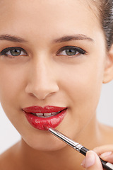 Image showing Happy woman, portrait and red lipstick with makeup for beauty or facial cosmetics on a white studio background. Face or closeup of female person or model applying color, gloss or glow for cosmetology