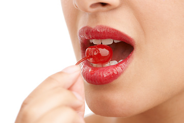 Image showing Person, mouth and bite with cherry, red lipstick or cosmetics for nutrition on a white studio background. Closeup of woman, teeth or natural organic fruit with makeup or gloss for diet, fiber or glow