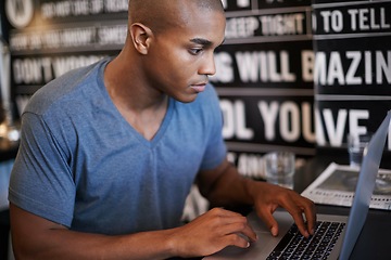 Image showing Freelance, serious and man with laptop for work in cafe, typing and internet with social media. Information technology and web search for job, African male person with online connection for business