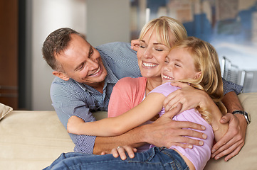 Image showing Excited, child and parents on sofa for love, relax and bonding together for calm peace on weekend. Father, mother or daughter for happy family with care, vacation or affection with hugging in lounge