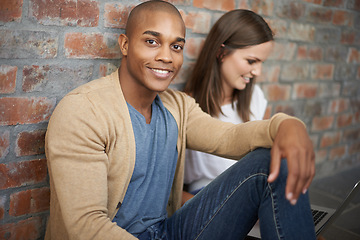 Image showing African man, university student and portrait in hallway, studying and smile with friend. Technology, laptop and learning for test or exam, gen z learners and diverse scholars sitting on campus floor